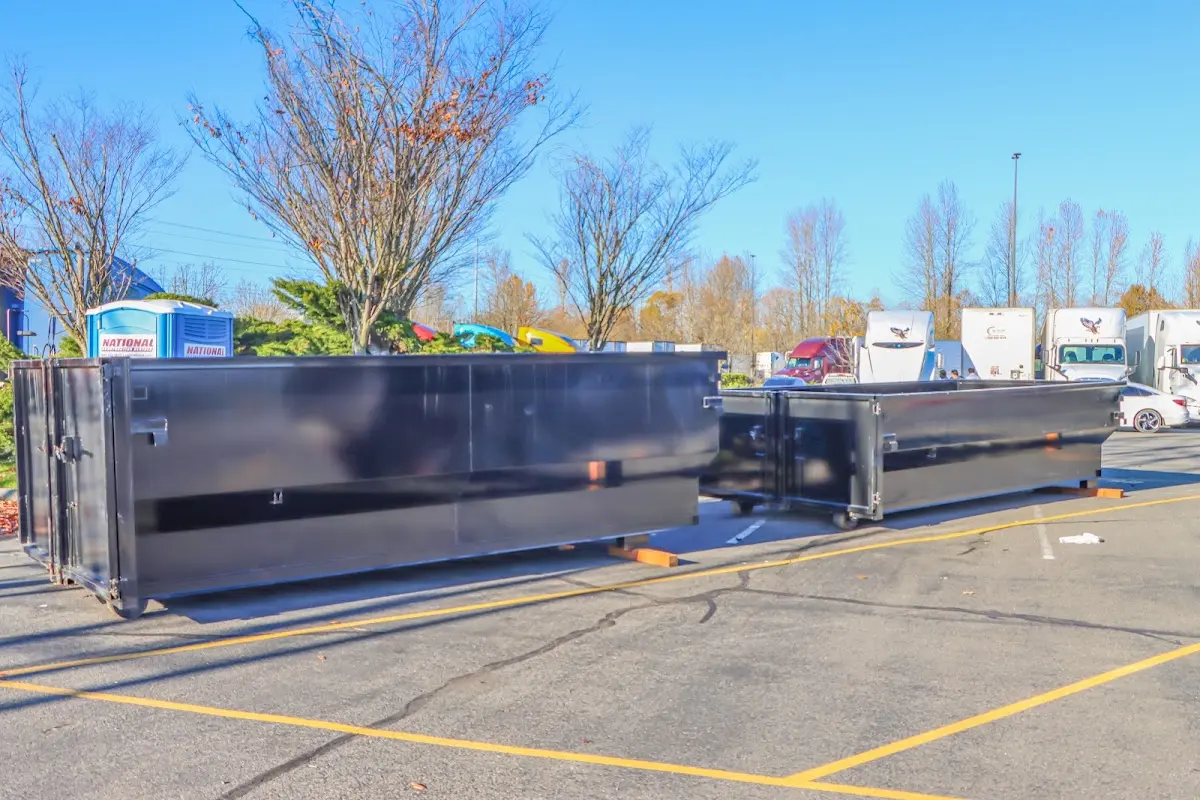 Professional dumpster rental service with roll-off container on residential driveway in Johnsburg